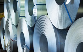 large rolls of steel coils stacked on top of each other