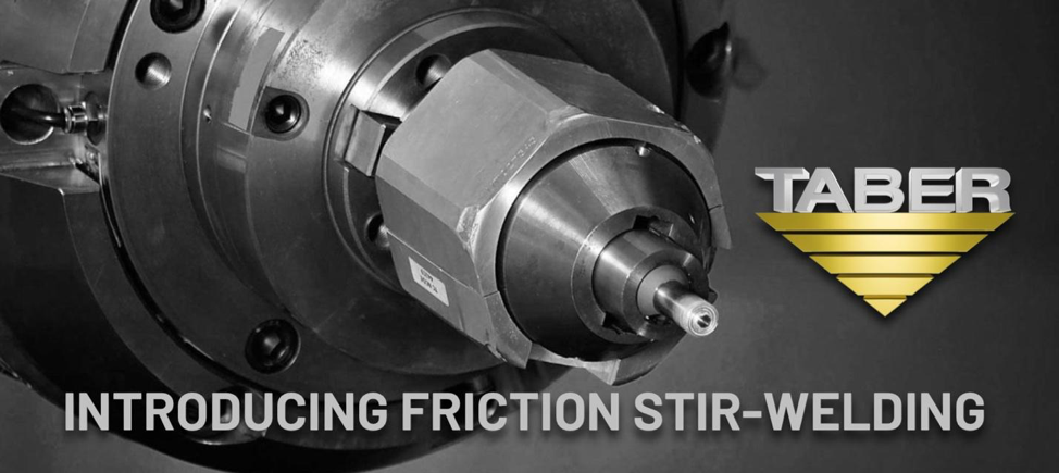 Black and white closeup image of the tip of a friction stir-welder, which resembles the tip of a drill, with Taber Extrusions’ official inverted gold triangle logo and the words, “Introducing Friction Stir-Welding.”