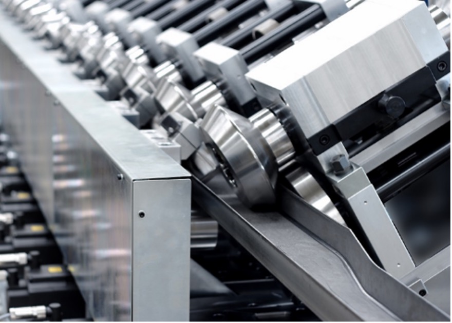 A series of metal rollers and mechanical components are aligned in a row as part of an industrial machine or manufacturing process. The setup appears designed for processing or shaping materials like metal sheets or strips.